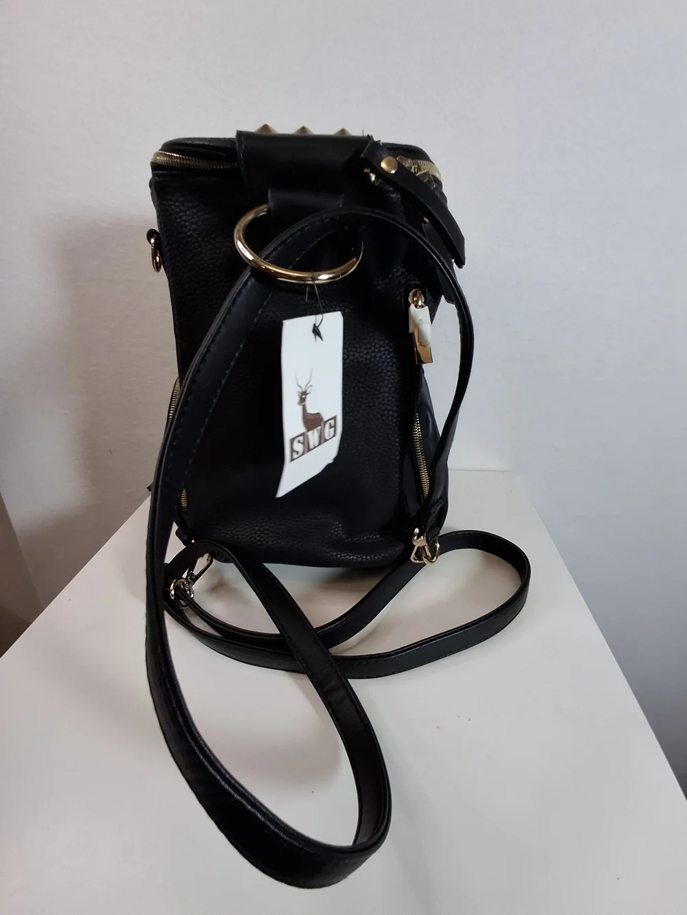 SWG Black Pebbled Sling Barrel Backpack with Gold Accents